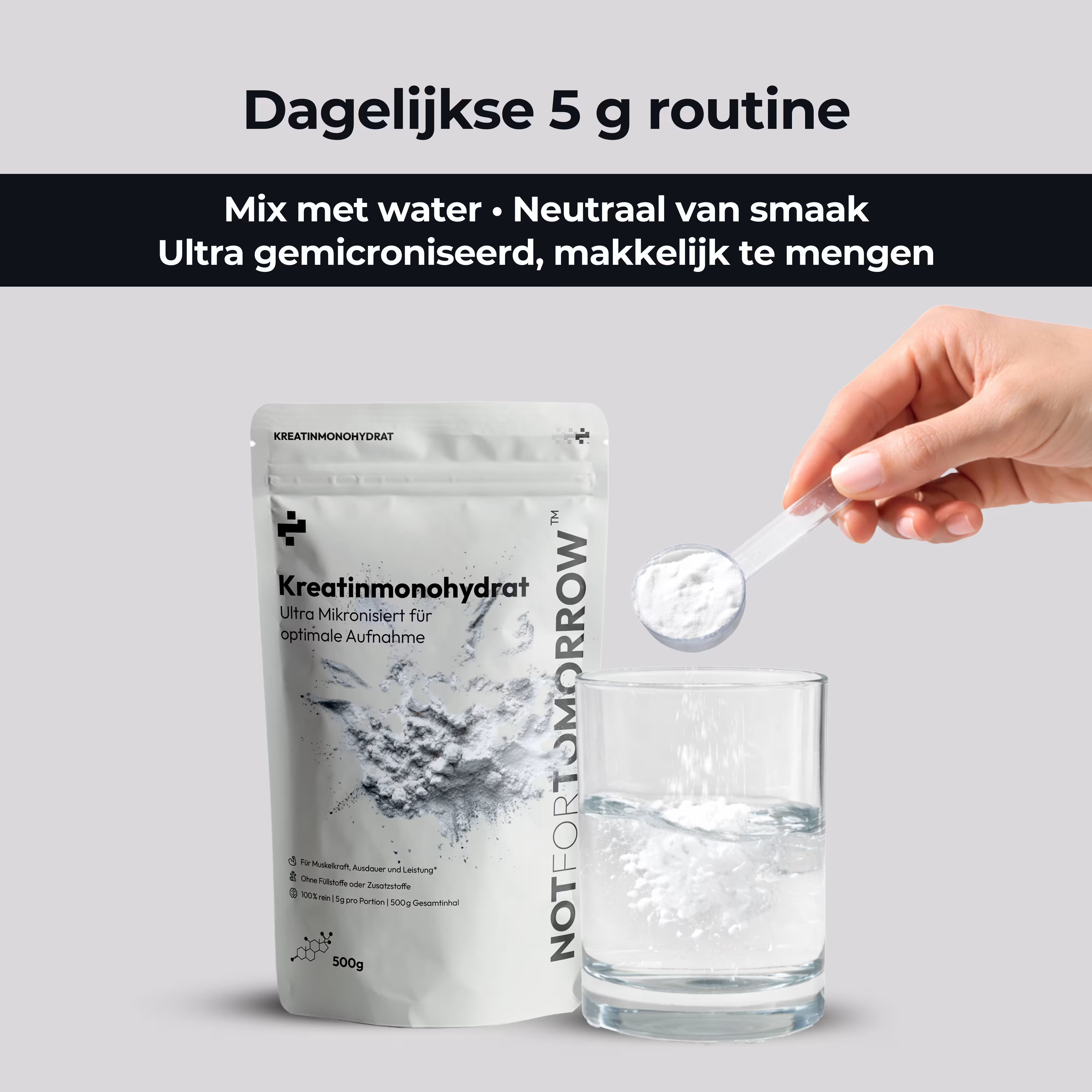 Scoop of creatine powder poured into a glass of water next to creatine monohydrate pouch