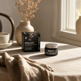 NOTFORTOMORROW Shilajit closed black box and amber jar with silver lid on a linen-covered table