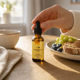 Hand pakt het NOTFORTOMORROW Vitamine D3 + K2 flesje op de ontbijttafel naast koffie en toast
